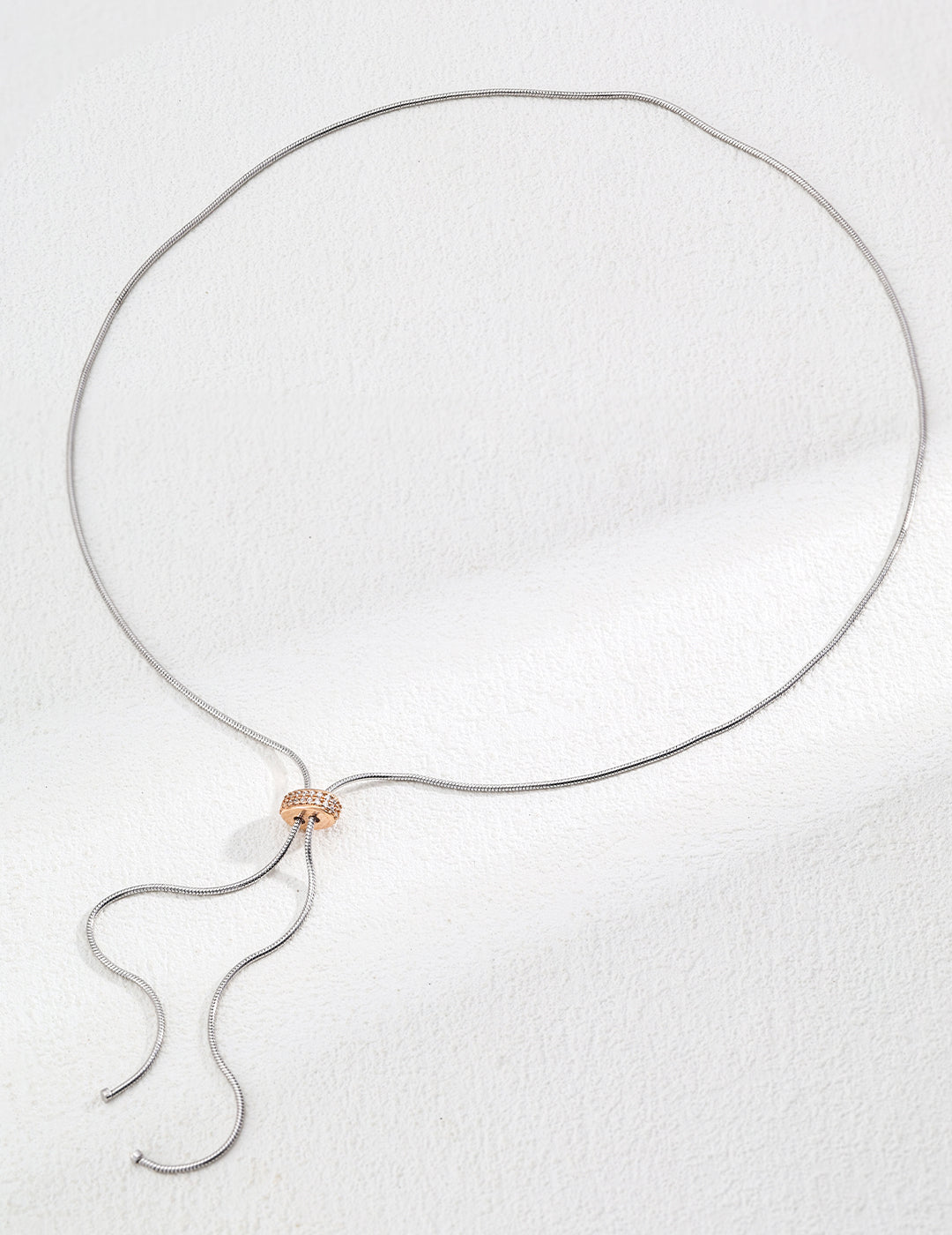 Handcrafted S925 sterling silver necklace featuring sparkling zirconia accents against a vintage gold or vintage gold with platinum finish. The adjustable 65cm chain allows for versatile styling, perfect for achieving a shorter, layered look or a dramatic, elongated style. 