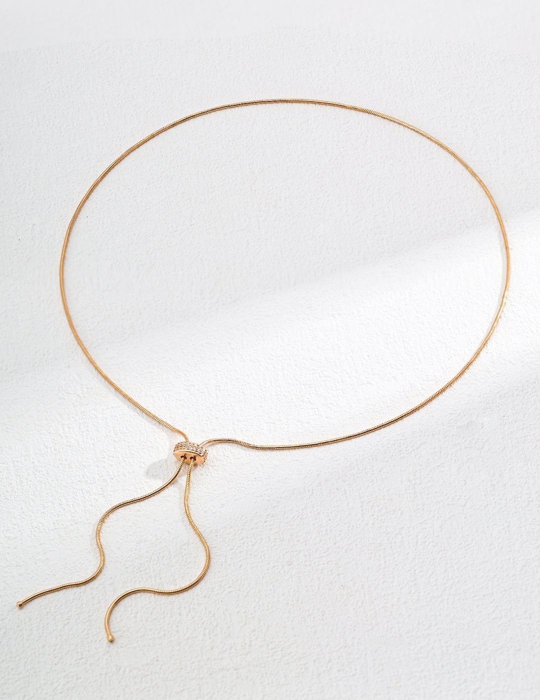 Handcrafted S925 sterling silver necklace featuring sparkling zirconia accents against a vintage gold or vintage gold with platinum finish. The adjustable 65cm chain allows for versatile styling, perfect for achieving a shorter, layered look or a dramatic, elongated style. 