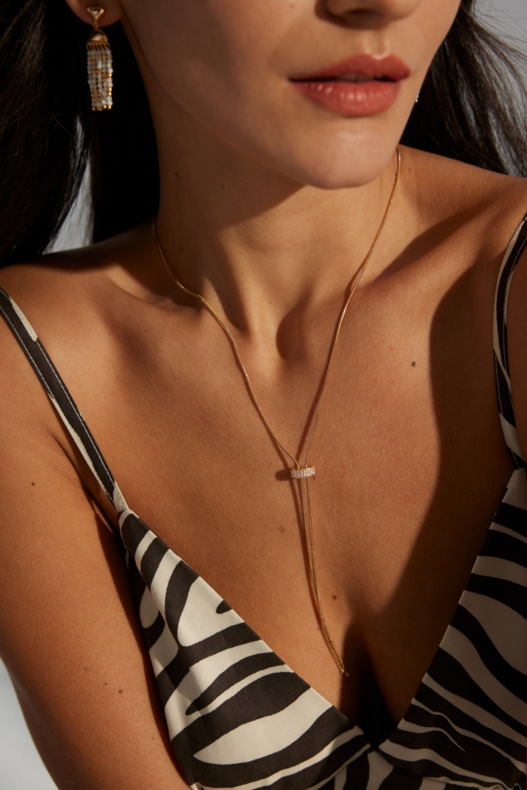 Handcrafted S925 sterling silver necklace featuring sparkling zirconia accents against a vintage gold or vintage gold with platinum finish. The adjustable 65cm chain allows for versatile styling, perfect for achieving a shorter, layered look or a dramatic, elongated style. 