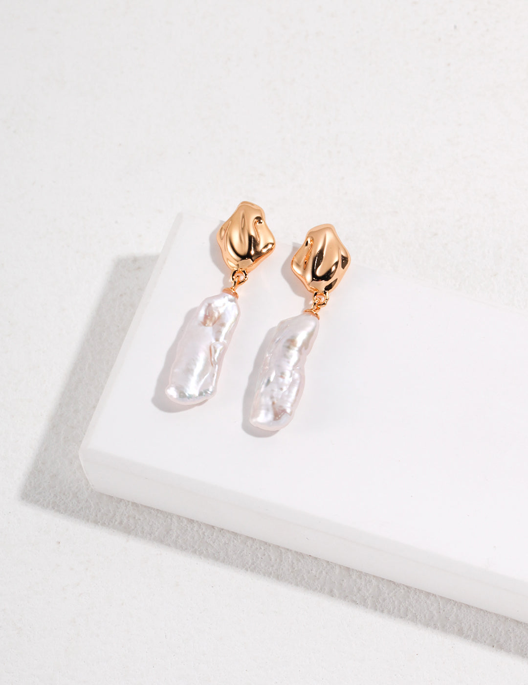 Sterling Silver Baroque Pearl Earrings made from S925 silver, featuring irregularly shaped natural baroque pearls. Approximately 44mm high and 12mm wide, available in white gold or vintage gold finishes, these earrings offer a sophisticated and elegant accessory.