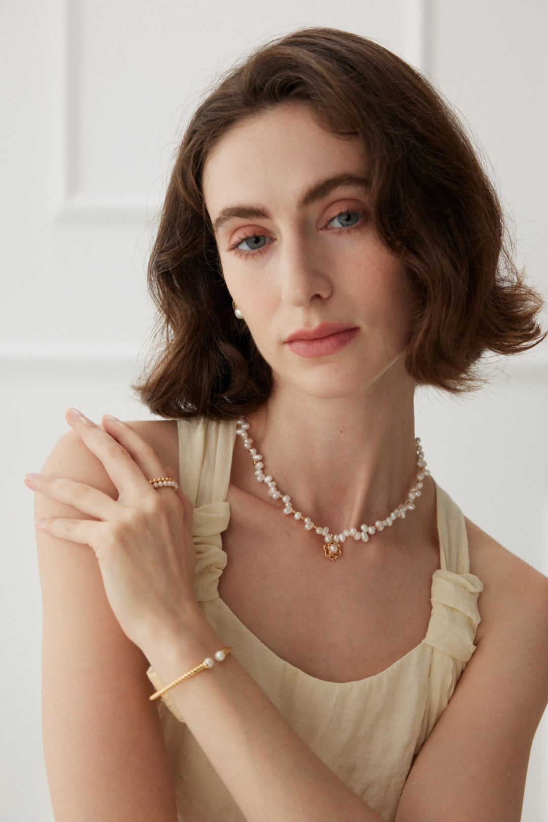 Chic camellia pendant necklace crafted from S925 silver with a vintage gold finish. The necklace features a 38cm chain with a 6cm extension and a beautifully detailed camellia pendant measuring 12.5mm in height, 12mm in width, and 5mm in thickness, adorned with 3mm to 4mm pearls. 