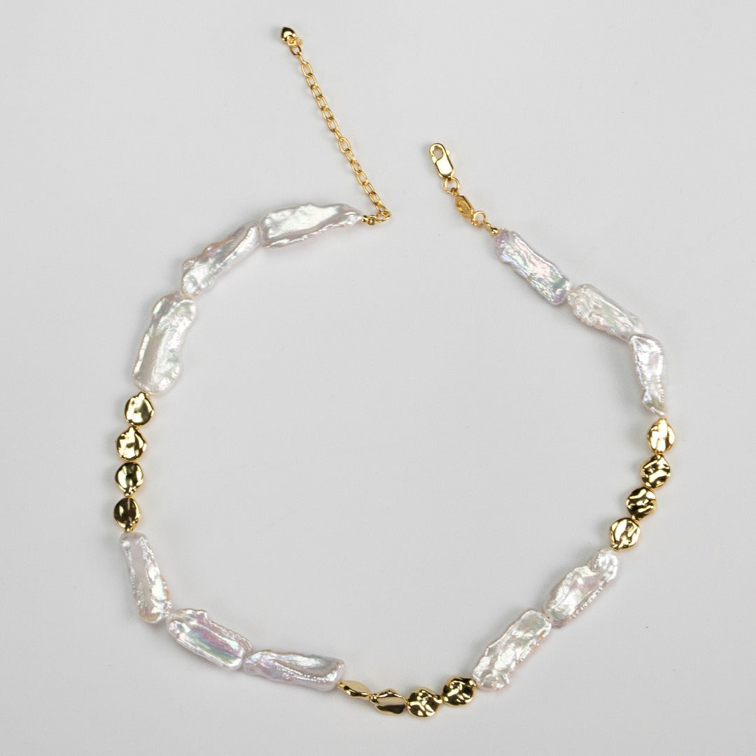 Elegant Light Luxury Natural Baroque Pearl Necklace crafted from S925 silver and finished in K gold. The necklace features a chain length of approximately 38cm plus a 5cm extension. The silver piece measures about 7-8mm wide, while the baroque pearls range from 9-10mm wide and 20-25mm long. Each baroque pearl showcases unique imperfections, adding authenticity and individuality to this graceful accessory designed to enhance your clavicle.