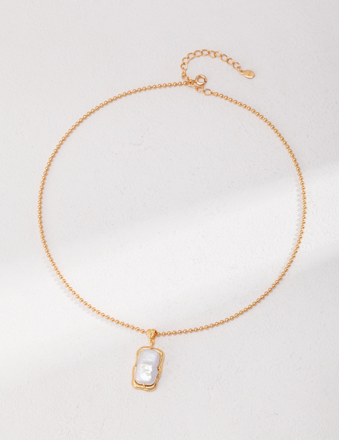 Natural rectangle baroque pearl necklace crafted from high-quality 925 silver with a vintage gold finish. This necklace features a unique rectangular baroque pearl pendant, measuring approximately 2cm high and 1cm wide, adding a modern twist to classic elegance. With a chain length of 39cm plus a 6cm extension, this necklace is perfect for everyday wear or special occasions, making it an ideal accessory for any jewelry collection.