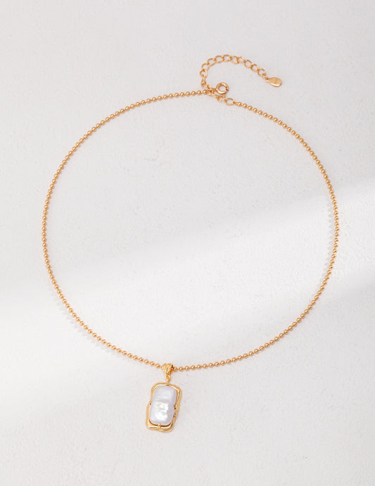 Natural rectangle baroque pearl necklace crafted from high-quality 925 silver with a vintage gold finish. This necklace features a unique rectangular baroque pearl pendant, measuring approximately 2cm high and 1cm wide, adding a modern twist to classic elegance. With a chain length of 39cm plus a 6cm extension, this necklace is perfect for everyday wear or special occasions, making it an ideal accessory for any jewelry collection.