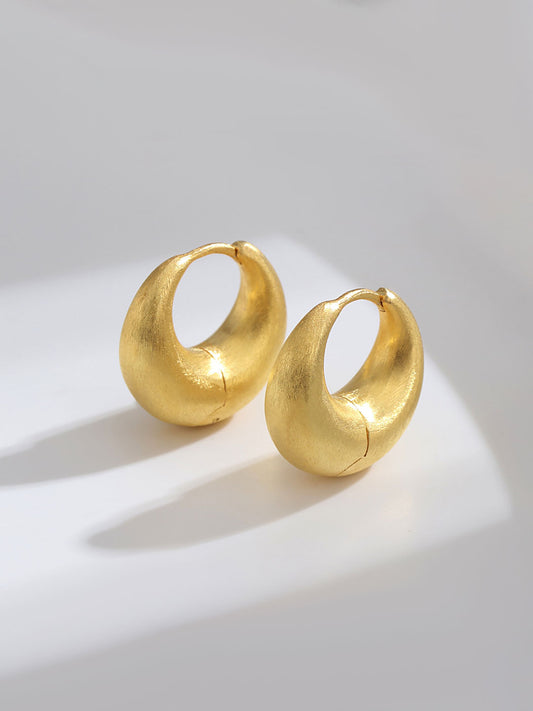 Bold statement sterling silver earrings in K gold with a chic French-inspired design. Measuring approximately 19mm in height, 20mm in width, and 10mm inner diameter, these earrings blend minimalist and exaggerated elements for a sophisticated yet playful look. Perfect for adding flair to any outfit, whether for a special event or everyday style.