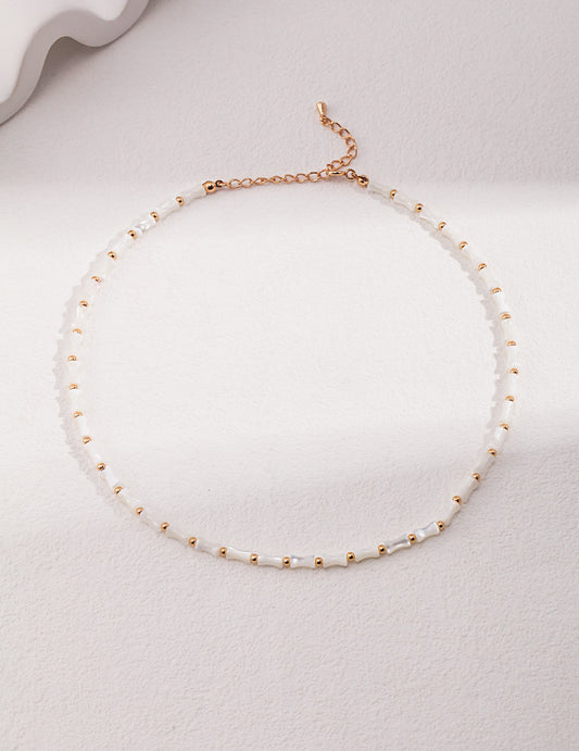 Sterling silver bamboo essence necklace featuring a minimalist design with a shimmering horseshoe shell accent in vintage gold. The necklace has an adjustable chain length of 38cm with a 6cm extension and a 4mm x 7mm horseshoe shell detail. A versatile piece that enhances both casual and formal looks with its nature-inspired elegance.