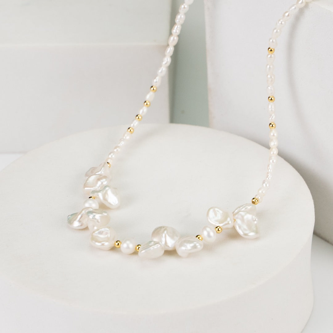 Sterling silver necklace featuring stone-shaped baroque pearls, inspired by morning dew. Crafted with S925 silver and K gold finish, with rice pearls and baroque pearls for a dreamlike elegance.