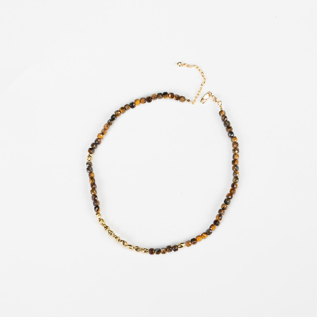 Stunning Sunset Tiger Eye Necklace crafted from S925 silver and featuring a natural tiger eye stone. The necklace measures approximately 39cm with a 5cm extension chain, showcasing a 5mm tiger eye stone and silver beads. The warm caramel hues of the tiger eye evoke a sunset's beauty, complemented by a retro gold finish, making it a versatile accessory for casual outings or special occasions.