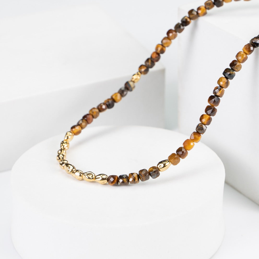 Stunning Sunset Tiger Eye Necklace crafted from S925 silver and featuring a natural tiger eye stone. The necklace measures approximately 39cm with a 5cm extension chain, showcasing a 5mm tiger eye stone and silver beads. The warm caramel hues of the tiger eye evoke a sunset's beauty, complemented by a retro gold finish, making it a versatile accessory for casual outings or special occasions.