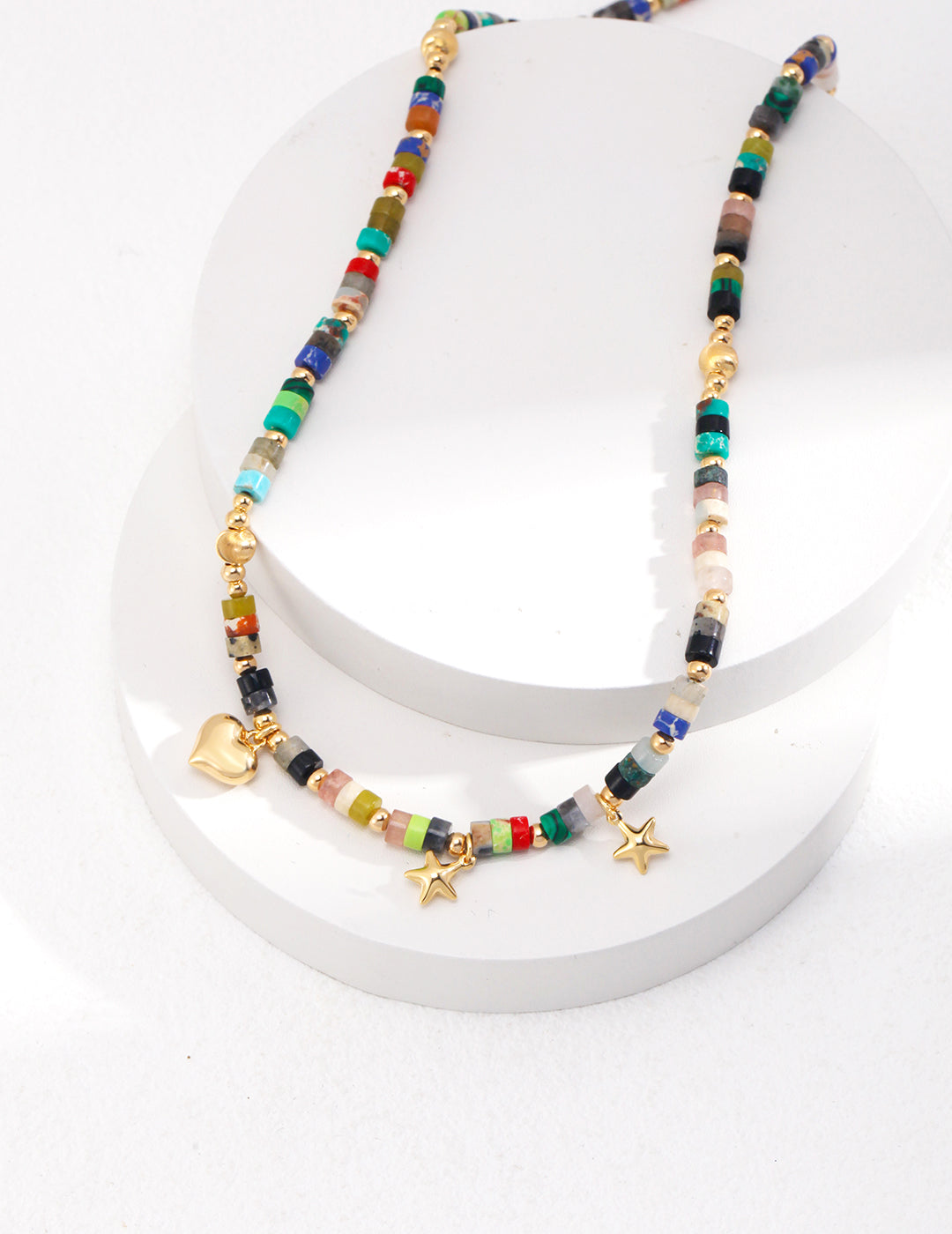 Playful 925 silver necklace in vintage gold featuring vibrant heart and star-shaped color stone beads. With an adjustable chain length of 36cm plus a 6cm extension, this whimsical design adds a joyful pop of color to any outfit, perfect for versatile styling.
