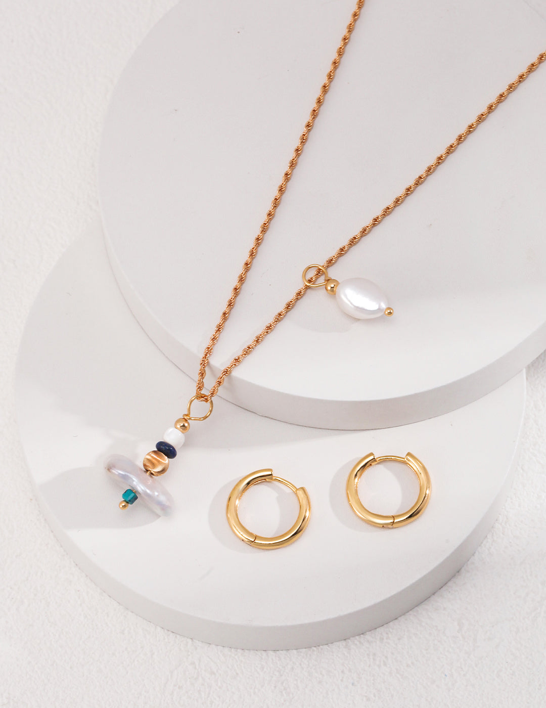 Handcrafted necklace in vintage gold finish, featuring 925 silver with pearls, lapis lazuli, phoenix pine, and mother-of-pearl. The design includes irregular pearls, a 4cm main pendant, and a 3.5cm smaller pendant, creating a sophisticated and unique look.